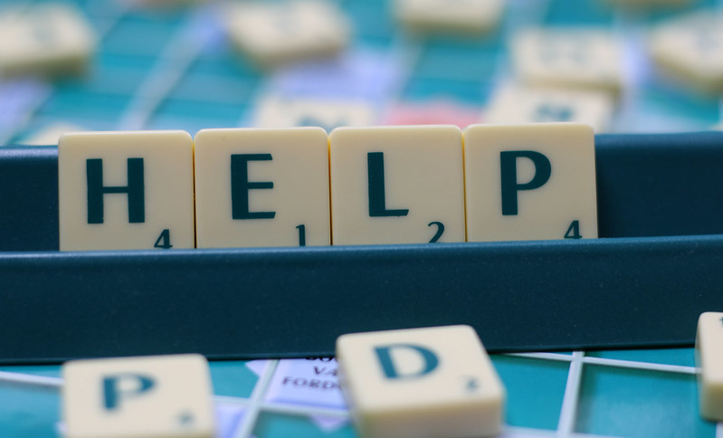Scrabble letter spell out "help"