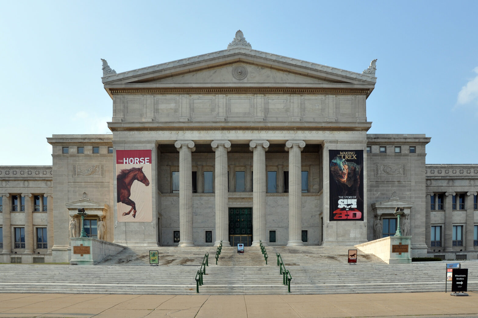 Large cement building with pillars and some hanging banners