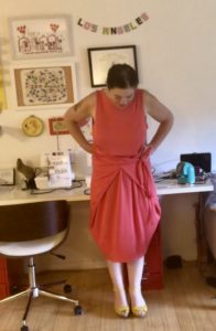 A woman in a coral-colored wrap dress